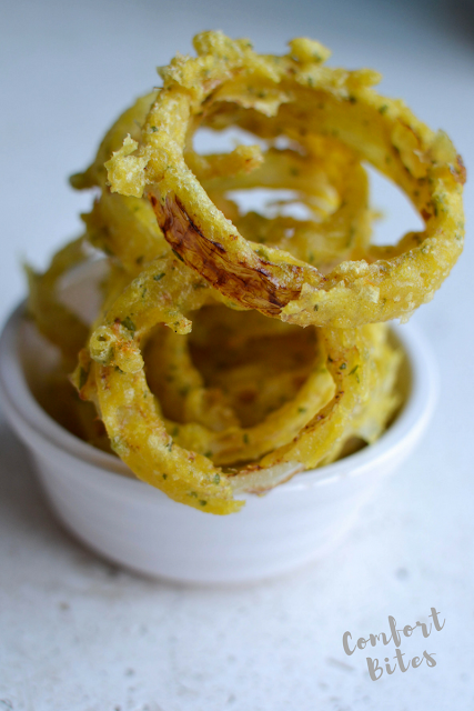 paleo and AIP autoimmune protocol compliant onion rings paleo gluten free onion rings piled up in a bowl