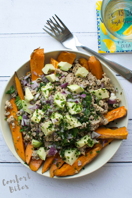 bowl of sweet potato fries topped with a turkey mixture cooked in herbs and spices
