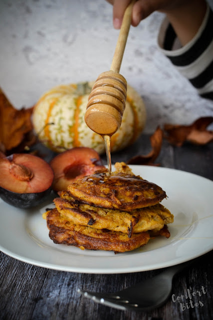 pile of paleo pancakes flavoured with warm spices, drizzled with honey