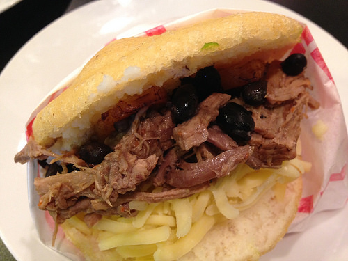 arepa with beans, cheese and meat with fried plantains Venezuelan food