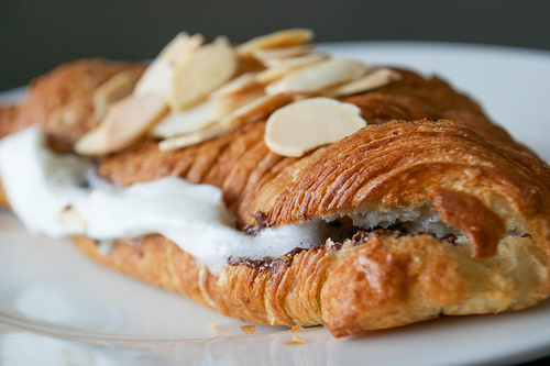 croissant with whipped cream toasted almonds and dark chocolate