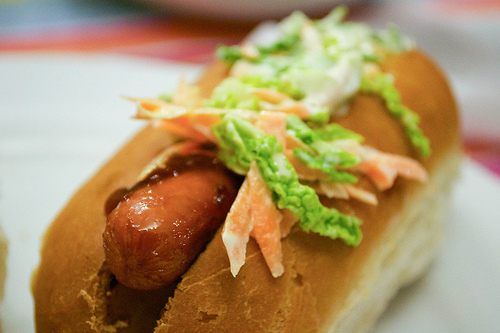hot dog with coleslaw and bbq sauce