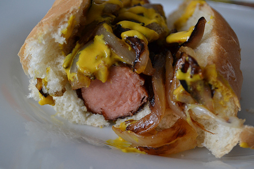 hot dog bitten mustard